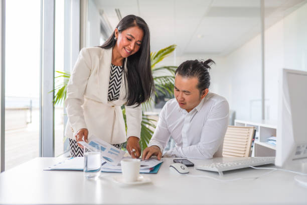 istock Two Asian Business People Working Together 1338400823