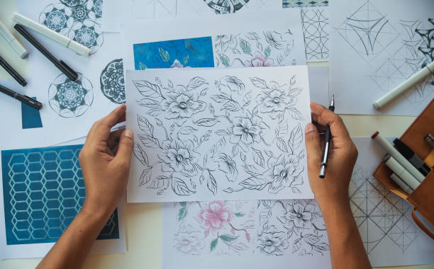 istock Designer designing drawing sketch pattern geometric flower seamless wallpaper fabric textile fashion industry. artistic design studio. 1338402537