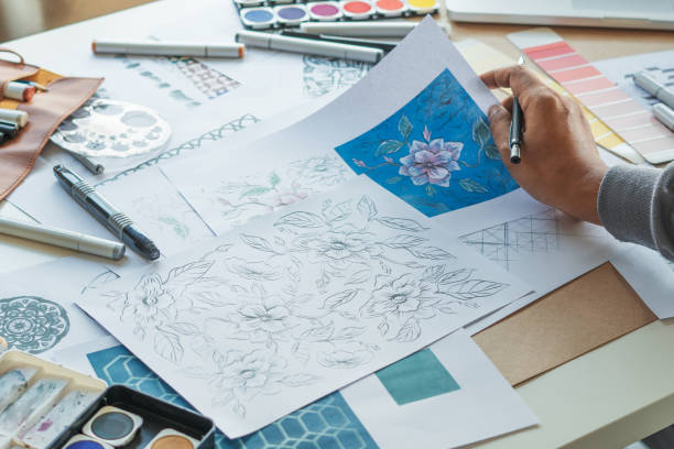 istock Designer designing drawing sketch pattern geometric flower seamless wallpaper fabric textile fashion industry. artistic design studio. 1338402540