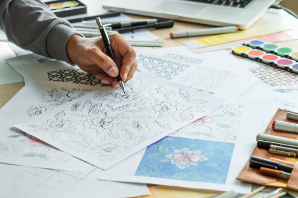 istock Designer designing drawing sketch pattern geometric flower seamless wallpaper fabric textile fashion industry. artistic design studio. 1338402542