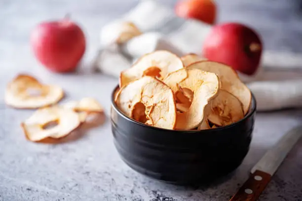 Dried apple chips in a bowl. toning. selective focus