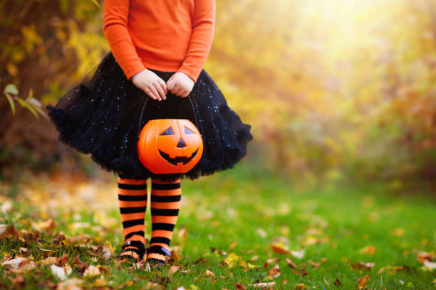 Little girl having fun on Halloween trick or treat stock photo