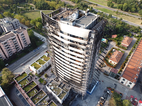 Milan, Italy - September 5, 2021: street view of the burned skyscraper Torre dei Moro in Milan, after the fire of August 29, 2021.