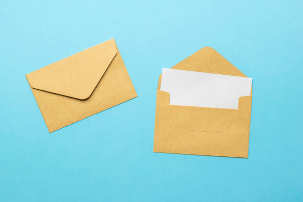 istock An open postal envelope with a sheet of white paper and a closed envelope on a blue background. Flat lay. 1338410573