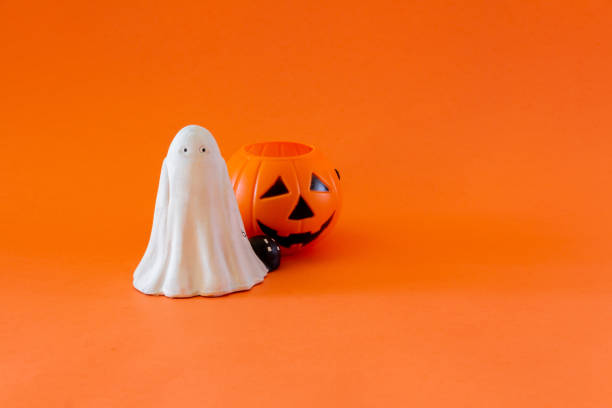 istock Halloween banner with ghost and pumpkin candy basket. Selective focus. Kids. Copy space. 1338410589