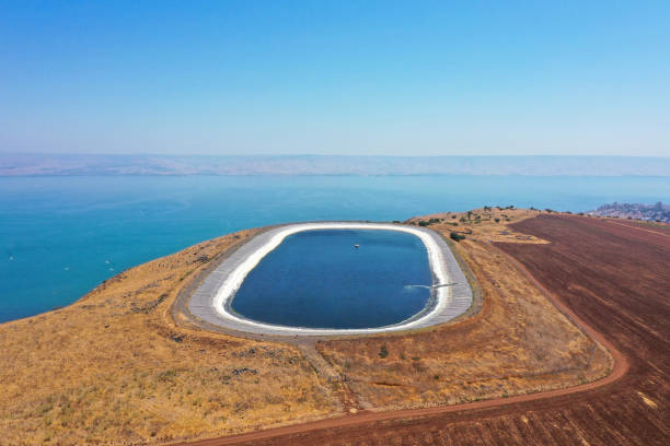Water reservoir on top of Arbel cliff overlooking The Sea of Galilee, Aerial view. stock photo