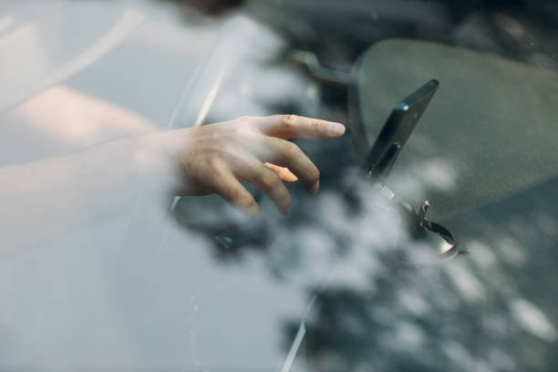 istock Navigator in car vehicle transportation commuter. Driver man using mobile phone navigator app while driving car 1338413931