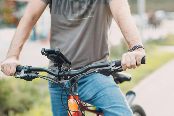 istock Man planning route using GPS navigation application in mobile phone on his bicycle bike. 1338413940