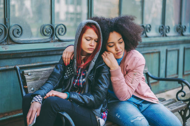 istock Young woman calming a depressed friend 1338414196