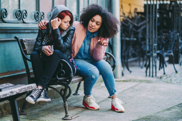istock Young woman calming a depressed friend 1338414268