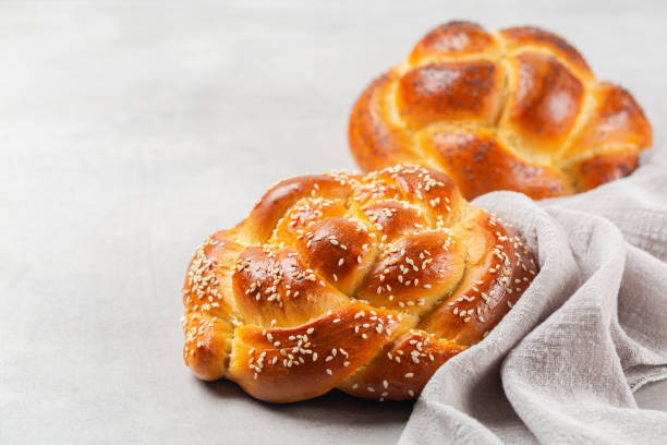 istock Homemade rose braid bread with sesame seeds and poppy seeds. Light grey background, copy space. 1338414847