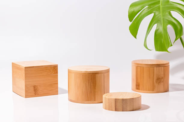 wooden podiums for product display and monstera leaves on white background - plant stand imagens e fotografias de stock