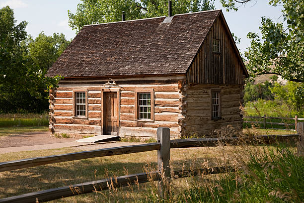 Teddy Roosevelt's Maltese Cross Log Cabin Teddy Roosevelt's Maltese Cross log cabin built from hand-hewn timbers and chinked with mortar. Selective focus.See  Rustic Log Cabins   here. theodore roosevelt national park stock pictures, royalty-free photos & images