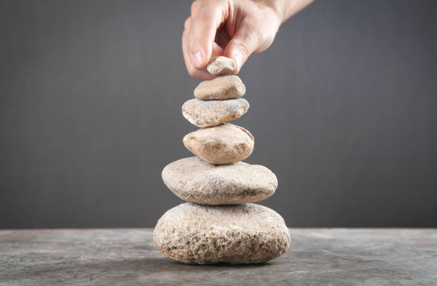 istock Male hand holding balance stone. 1338423146