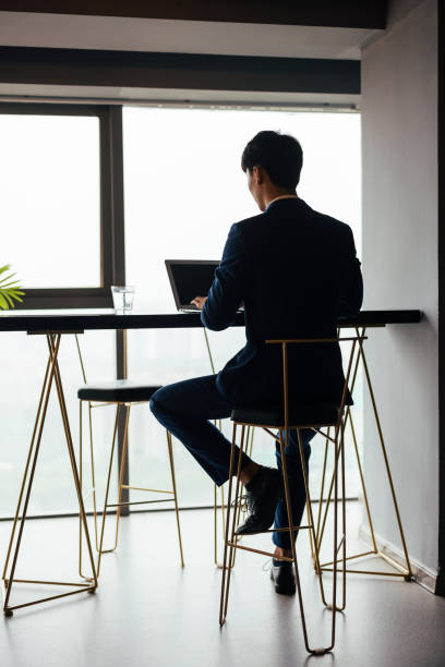 istock Young male businessmen work with laptops in the office 1338425346
