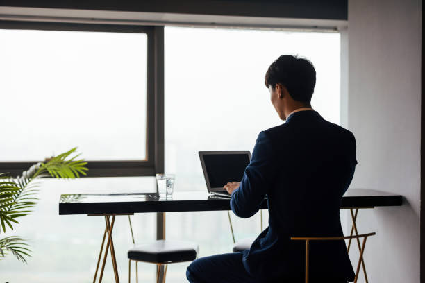 istock Young male businessmen work with laptops in the office 1338425356