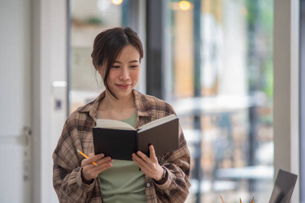 istock Businesswoman reading a book in her office 1338427284