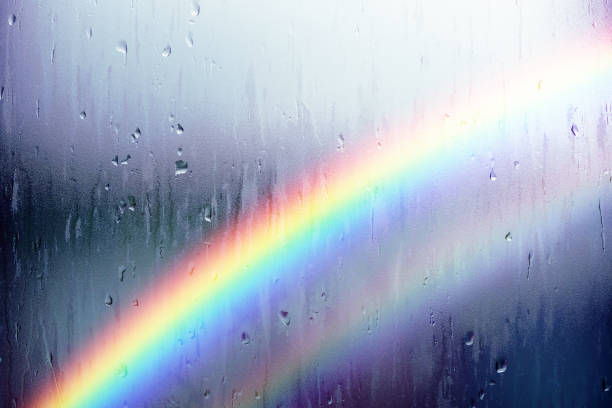 Rainy Day Concept. Rainbow as Outside. Water Droplet Texture Background, Rain Drops on Glass Window