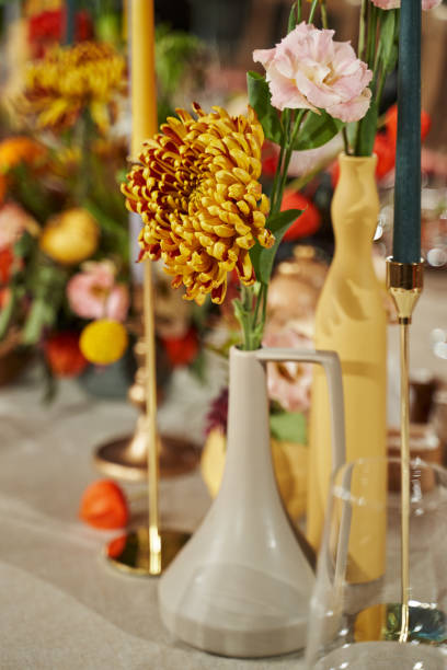 istock table decor for the autumn holiday. orange chrysanthemum on the table 1338428197