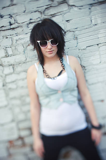 istock young woman against old wall 133842983