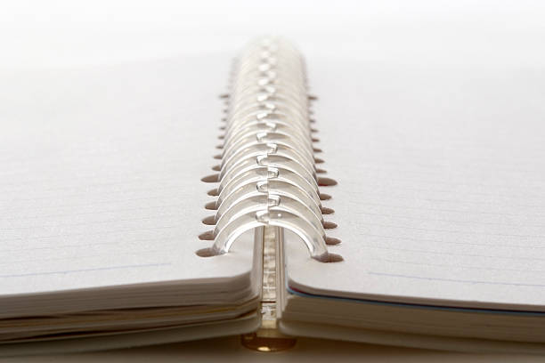 istock Close-up of opened blank spiral notebook against white background 133843022