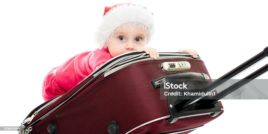 Christmas baby in the suitcase Christmas baby in the suitcase on a white background. 12-17 Months Stock Photo