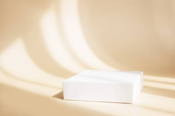 Abstract empty white podium on pastel beige background with shadow. Mock up podium for beauty product presentation and exhibitions. Abstract stand for cosmetic product. Minimal concept. Copy space. Abstract empty white podium on pastel beige background with shadow. Mock up podium for beauty product presentation and exhibitions. Abstract stand for cosmetic product. Minimal concept. Copy space. competition round photos stock pictures, royalty-free photos & images