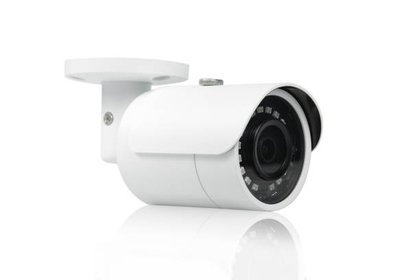 istock Surveillance CCTV security camera on the wall on white background. 1338434590