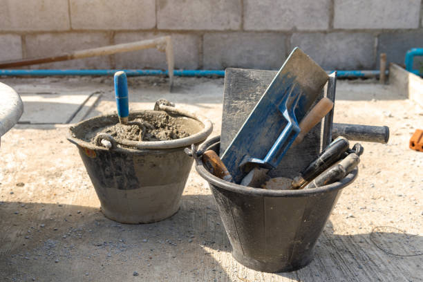 istock Dirty trowel and bucket with mortar 1338436776