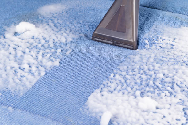 istock cleaning a dirty blue soft sofa with special foam using a brush on a vacuum cleaner 1338439012