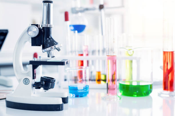istock Microscope and test tubes with lab glassware in laboratory background, research and Scientific concept 1338439509