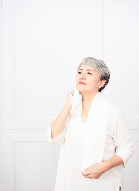 istock Active mature female refreshing and wipe sweat during workout. 1338440804