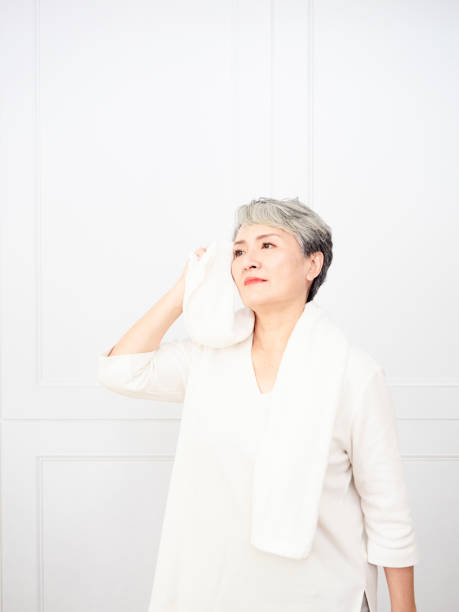 istock Active mature female refreshing and wipe sweat during workout. 1338440819