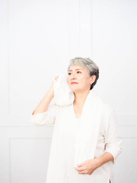 istock Active mature female refreshing and wipe sweat during workout. 1338442789