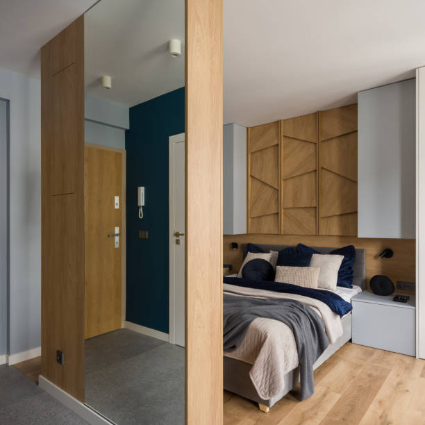 istock Stylish bedroom behind wall with mirror 1338445013