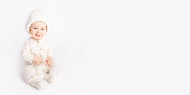 istock baby crawls in a warm suit and hat on a white isolated background, space for text 1338449002