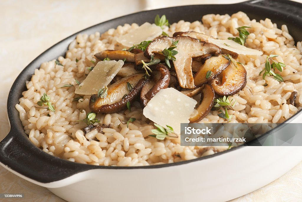 Risotto Wild mushroom risotto with herbs and grated parmesan Risotto Stock Photo