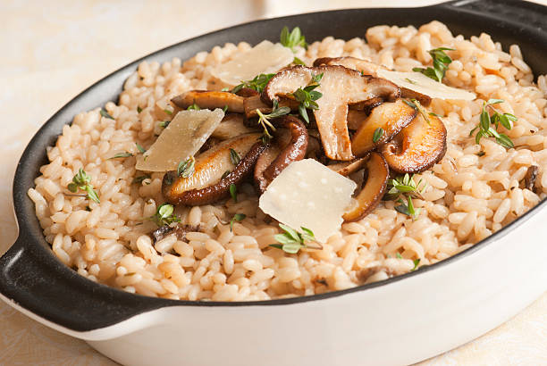 Risotto Wild mushroom risotto with herbs and grated parmesan shiitake mushroom photos stock pictures, royalty-free photos & images