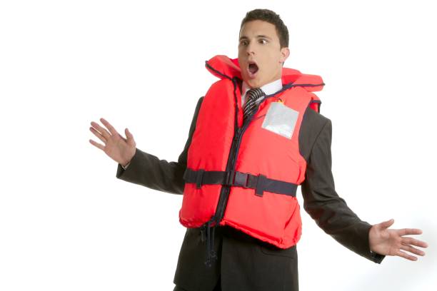 businessman sinking in crisis, lifejacket metaphor - life jacket isolated red safety imagens e fotografias de stock