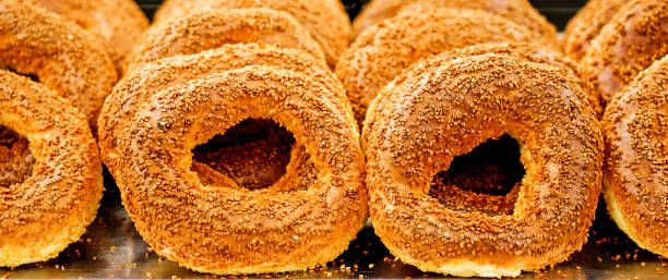 istock Closeup of traditional Turkish bagel simit on tray. Suitable for header or banner. 1338456087