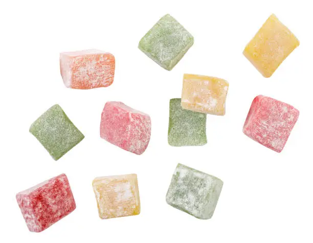 Photo of Multi-colored Turkish delight drops on a white background, Turkish delight levitating. Isolated