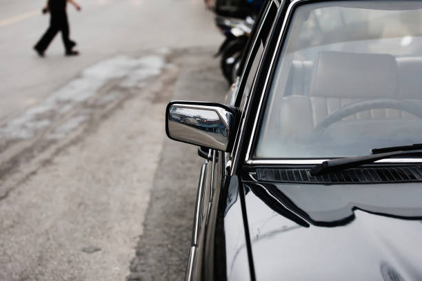 istock Front-side view of classic black car parked along a street. 1338462247