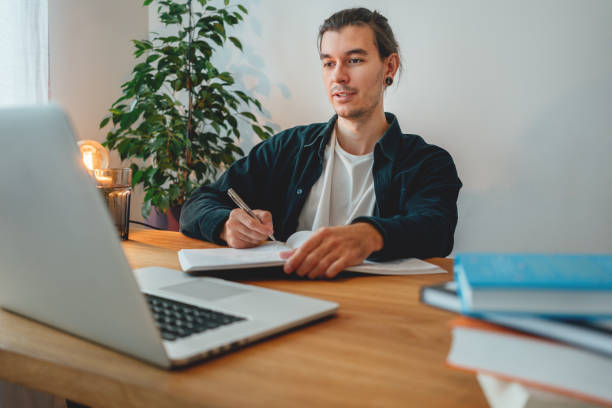 istock University student studying and making notes at campus. Adult student prepare for pass exam 1338463367