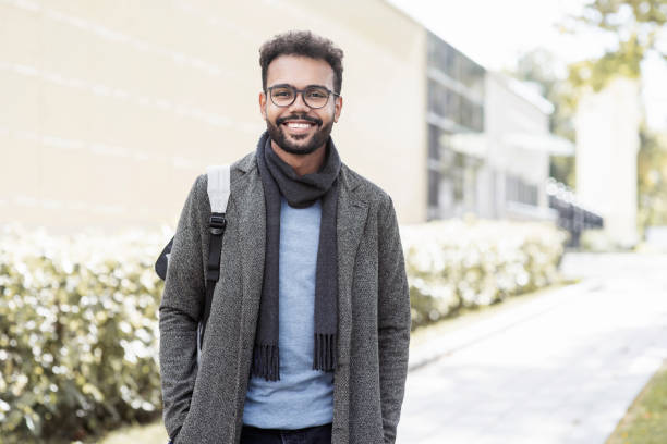 istock Handsome young man wearing warm clothing looking at camera 1338463373