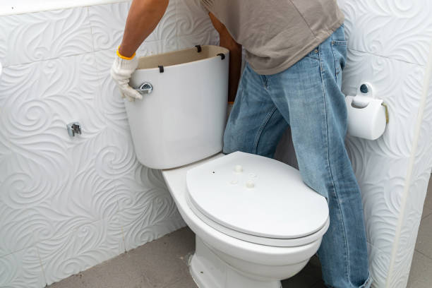 istock workerman performs repair of toilet bowl 1338465929