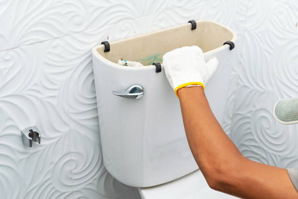 istock workerman performs repair of toilet bowl 1338465930