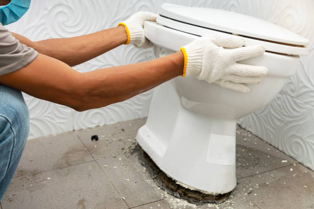 workerman performs repair of toilet bowl workerman performs repair of toilet bowl, To repair the pipe from the toilet toilet bowl stock pictures, royalty-free photos & images