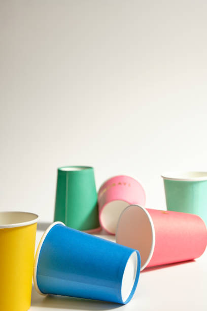 istock vertical image of a group of colored cardboard cups randomly placed on gray background 1338470313