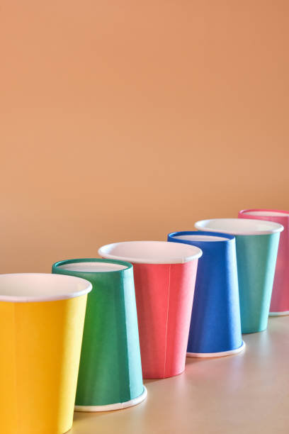 istock colored cardboard glasses diagonally on orange background with side light 1338470374
