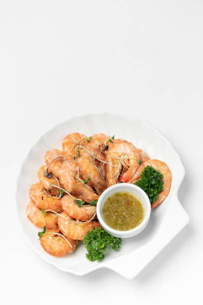 istock fresh boiled prawns with zesty citrus dipping sauce on white background 1338475138